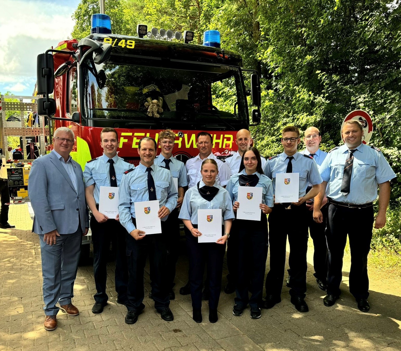 Gruppenbild vor Feuerwehrfahrzeug